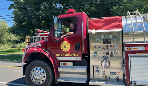 Process quality manager and volunteer firefighter Chuck Cooper driving a water tender truck to a nearby fire.